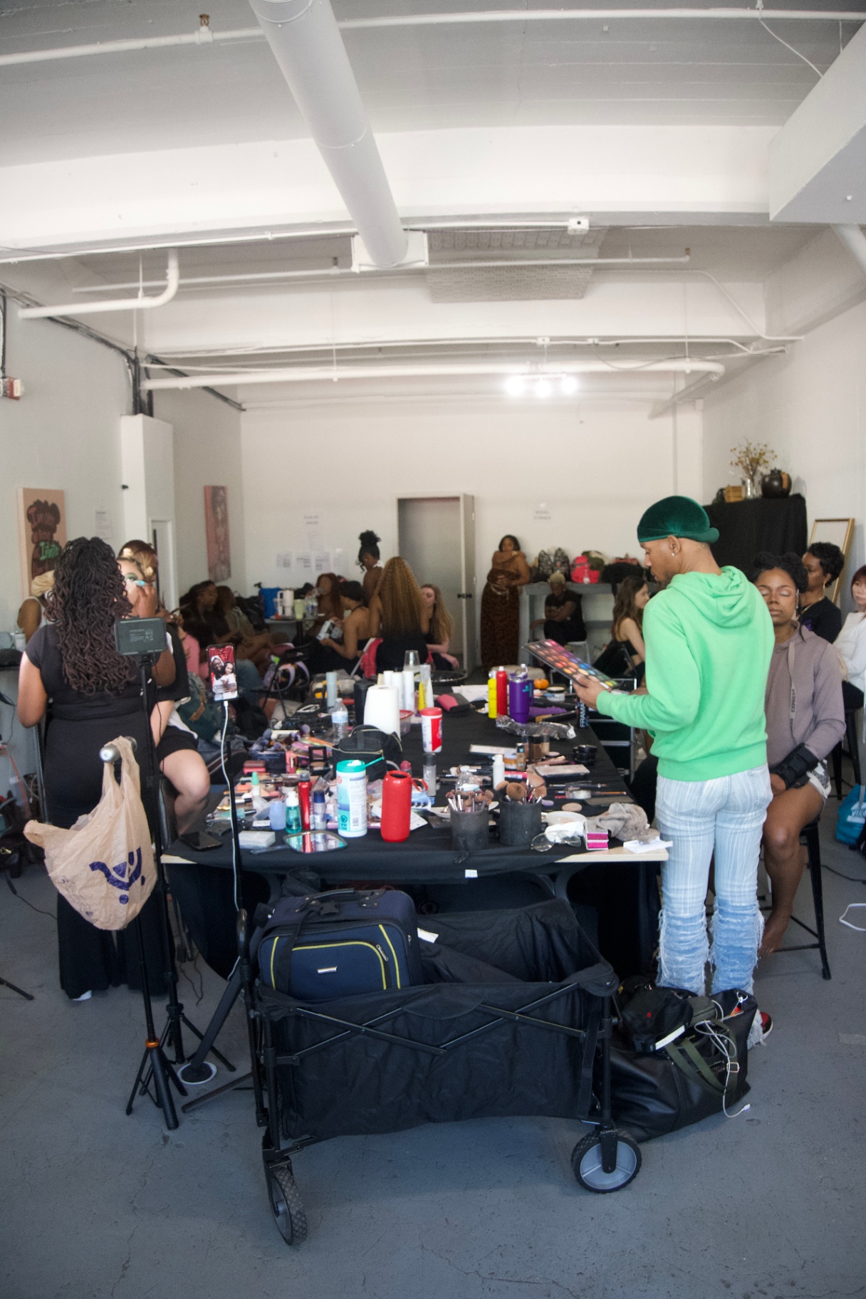 Wide shot of the backstage glam room in full swing