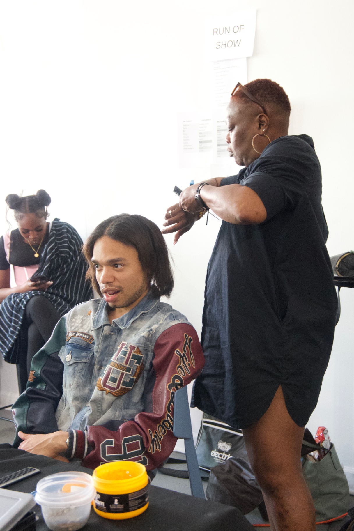Model getting a fresh silk press in the hair chair