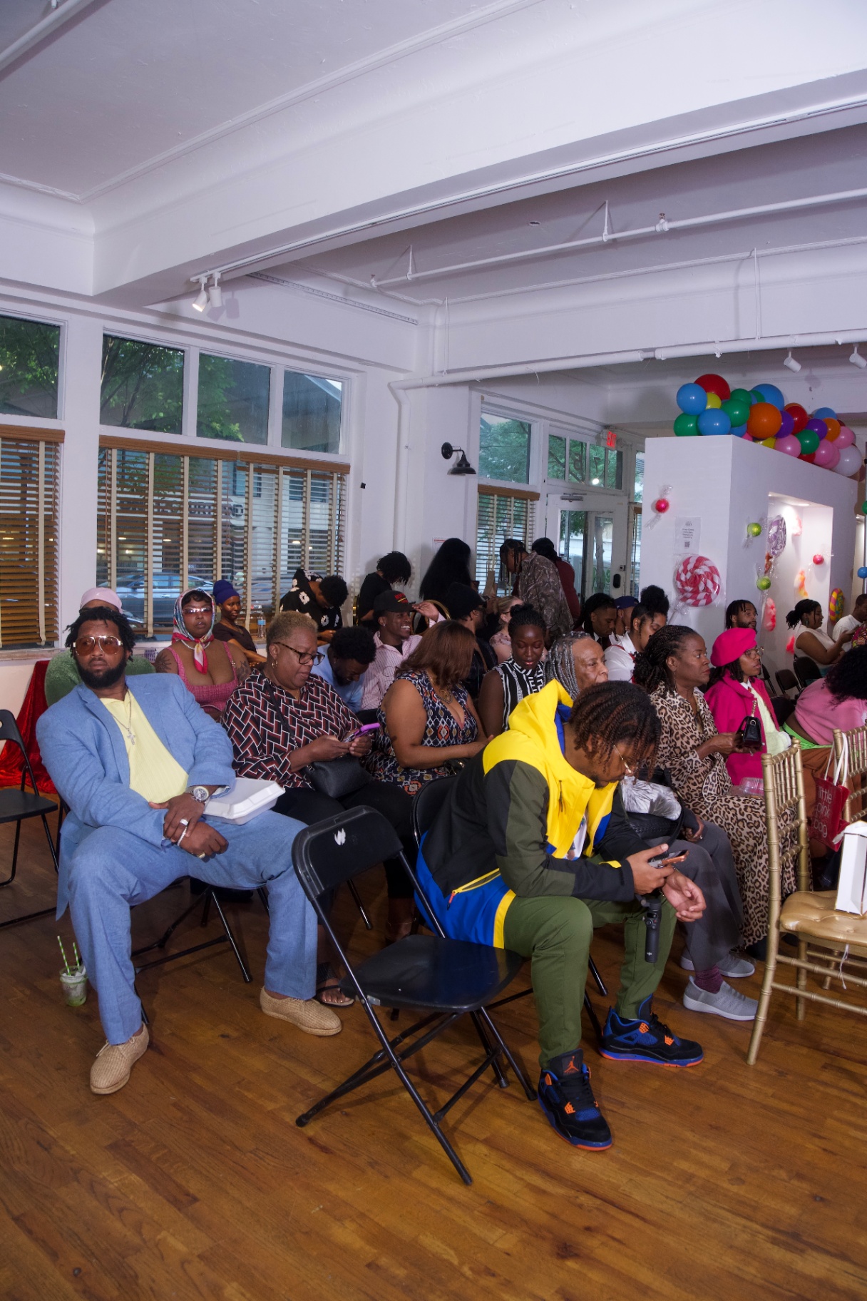 Wide shot of the seated audience in front of the candy display