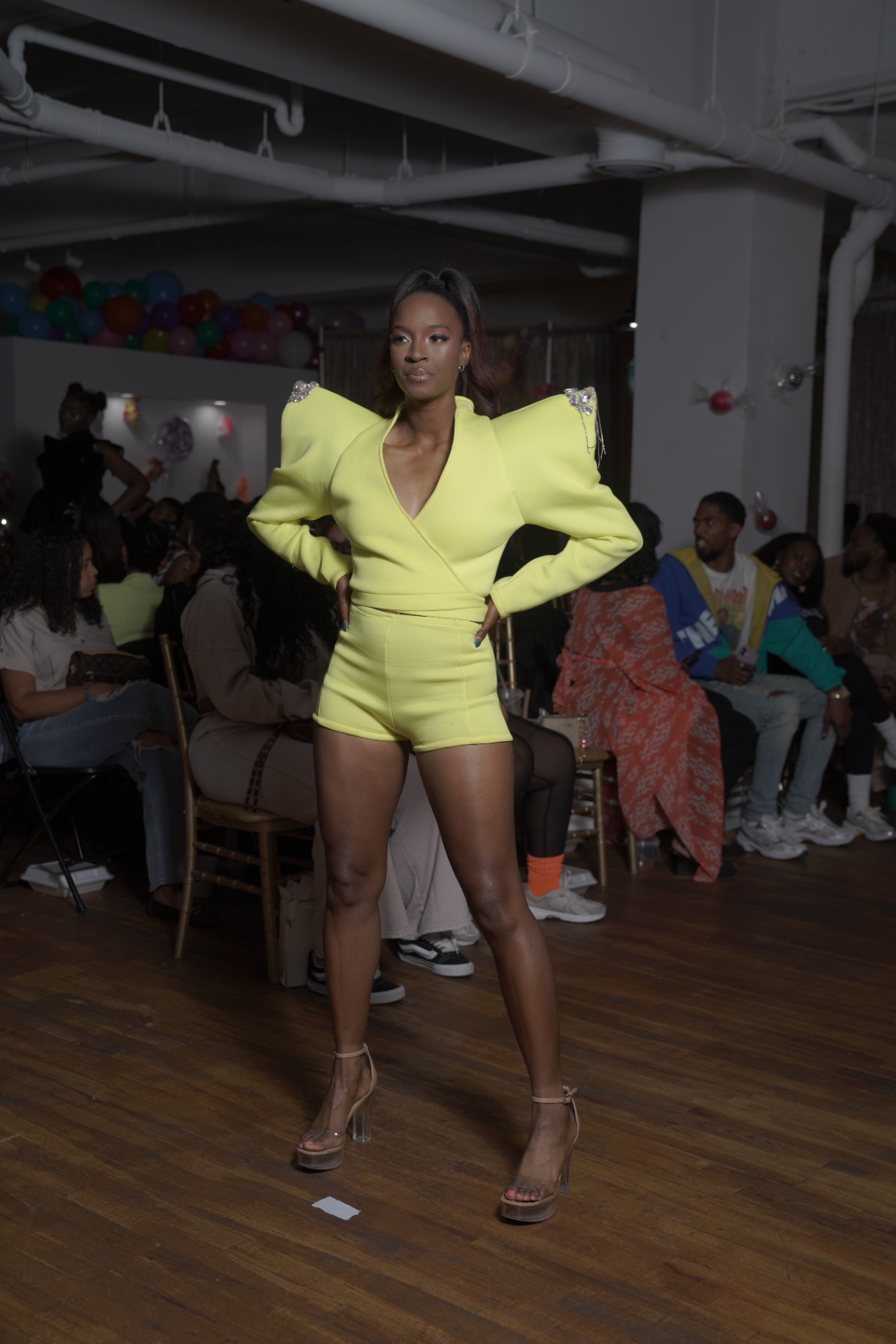 Model in a chartreuse power suit with structured shoulders