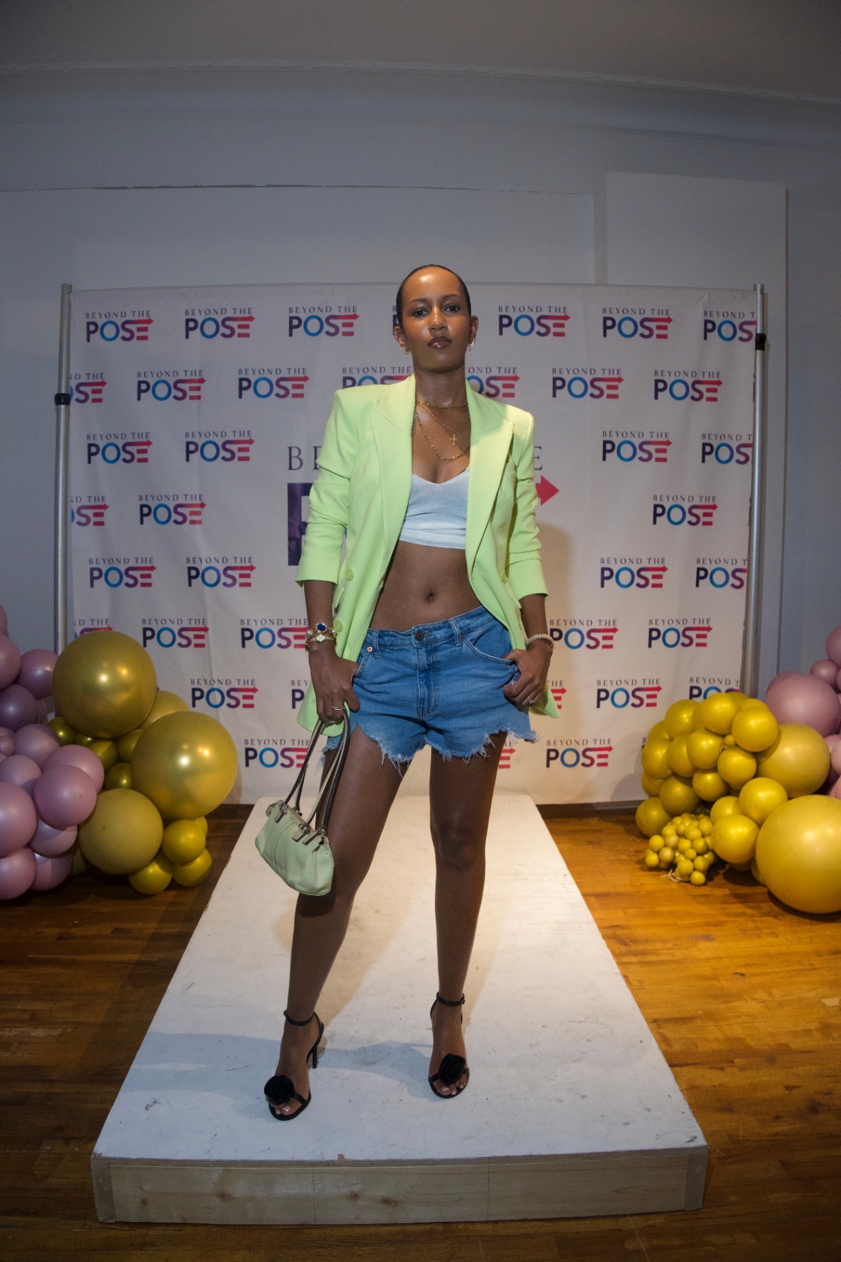 Guest in a lime blazer and denim shorts on the Beyond the Pose backdrop